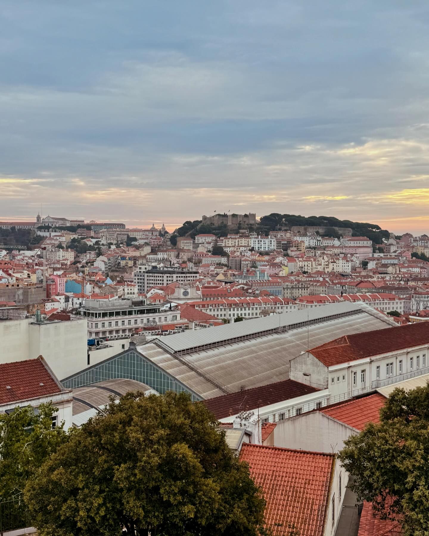 17 Best Indoor Things To Do In Lisbon When it Rains 3 Panoramic view of Lisbon's historic city center with red rooftops, iconic architecture, and the castle on the hill in the background, perfect for indoor activities in rainy Lisbon.