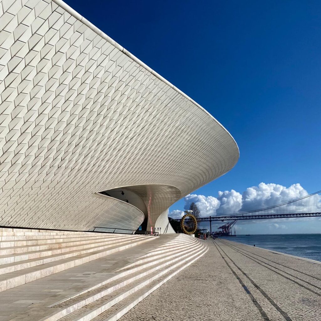 Contemporary architectural building in Lisbon with sleek white design and waterfront views, perfect for spring visits.