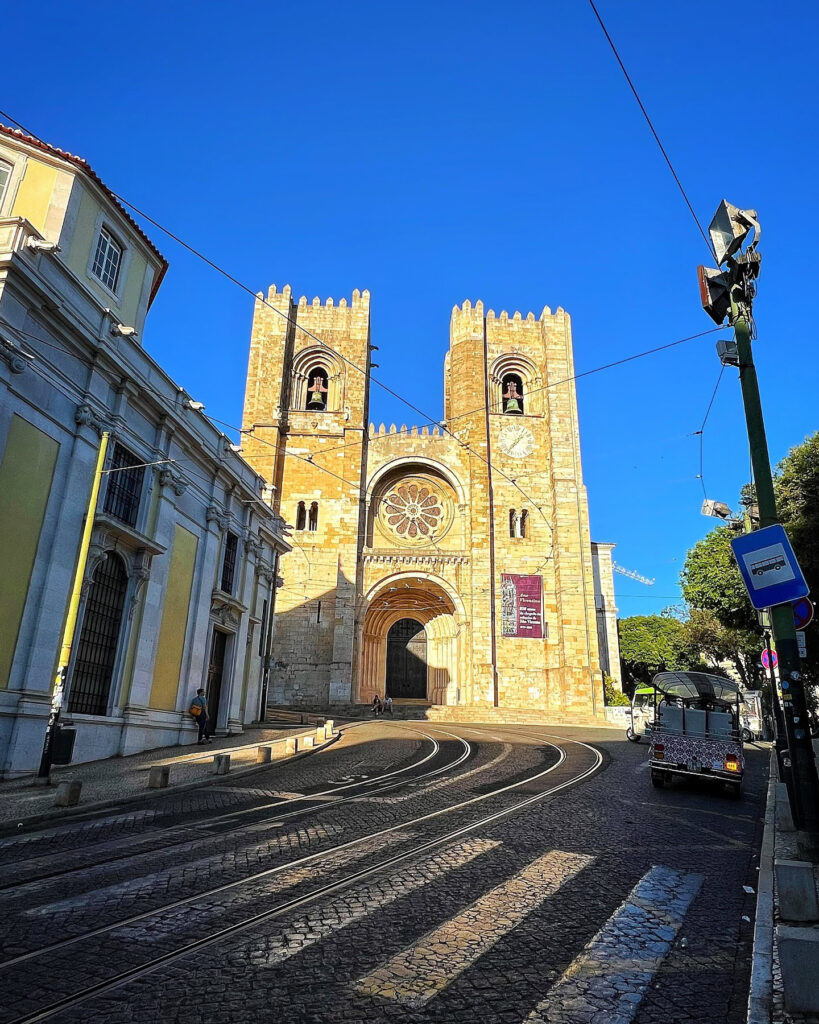Lisbon in April: The Perfect Time To Visit 4 Historic Lisbon Cathedral with twin towers and intricate facade under a clear blue sky.
