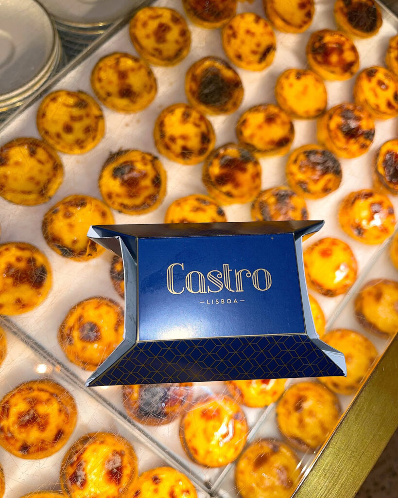 Portuguese custard tarts displayed at Lisbon bakery, showcasing authentic Portuguese pastry art and local culinary delights. Perfect for exploring Lisboa's vibrant food scene.