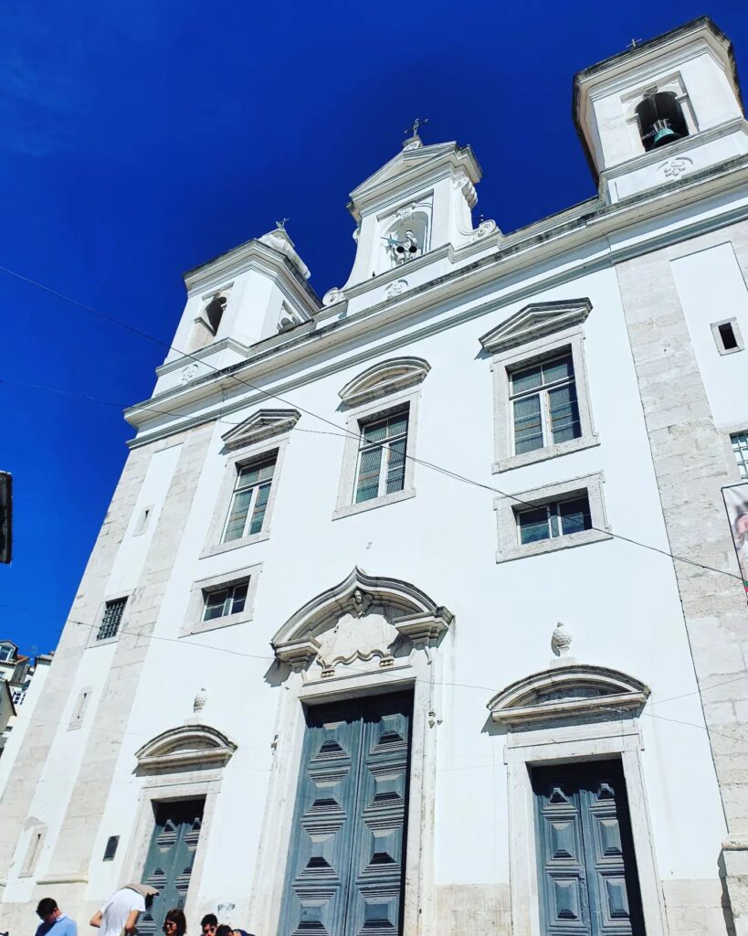 Alfama Church in Lisbon with its historic white facade and baroque architecture, a key landmark in the Alfama district, showcasing Portugal's rich cultural heritage.