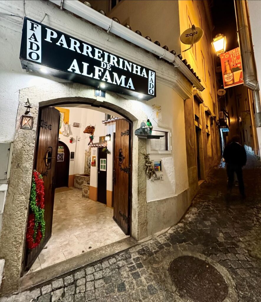 Traditional Fado house entrance in Alfama, Lisbon, showcasing authentic Portuguese music culture in a cozy, historic setting.