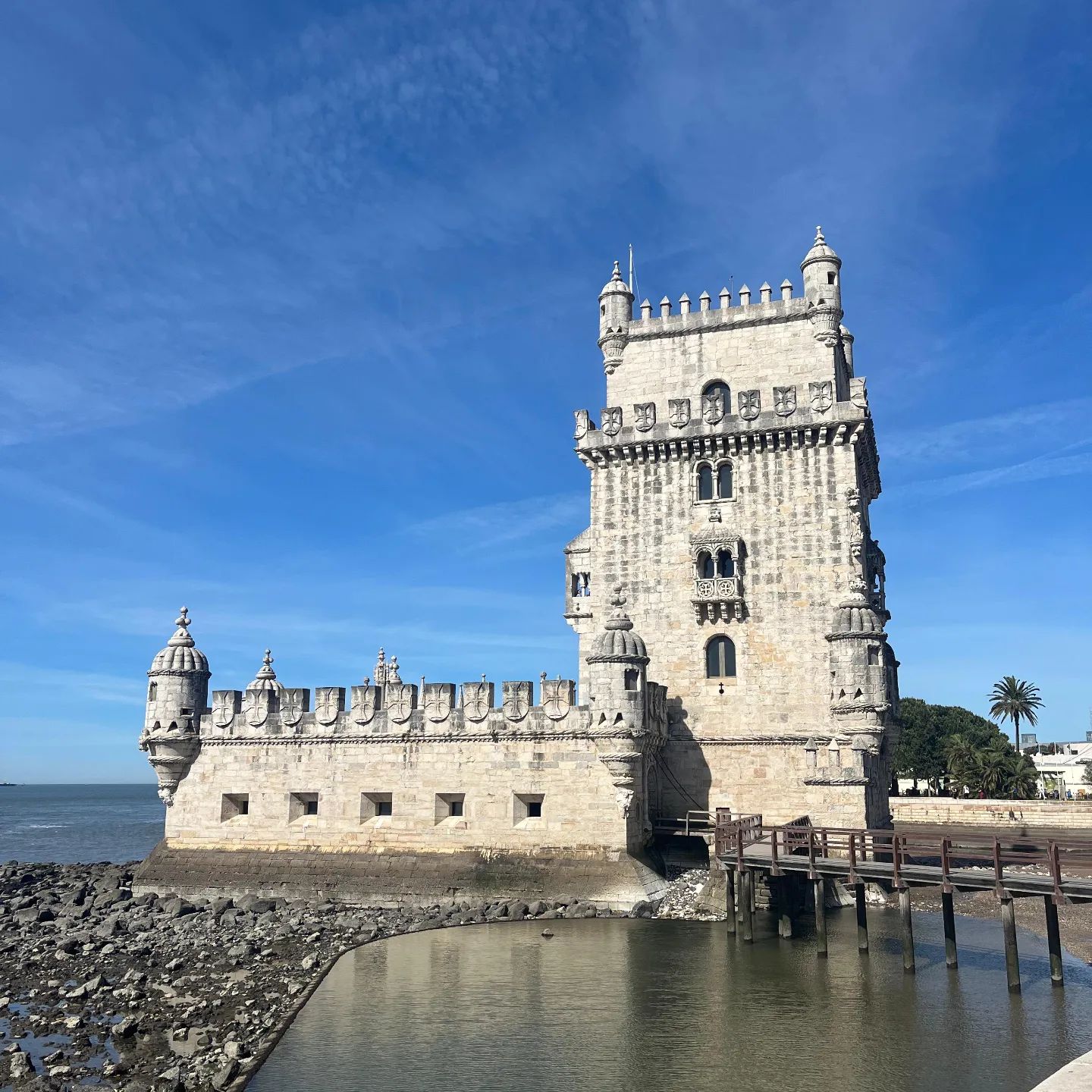 Historic Belém Tower along the Tagus River in Lisbon, Portugal, showcasing iconic medieval architecture and a popular tourist attraction in Belém district.