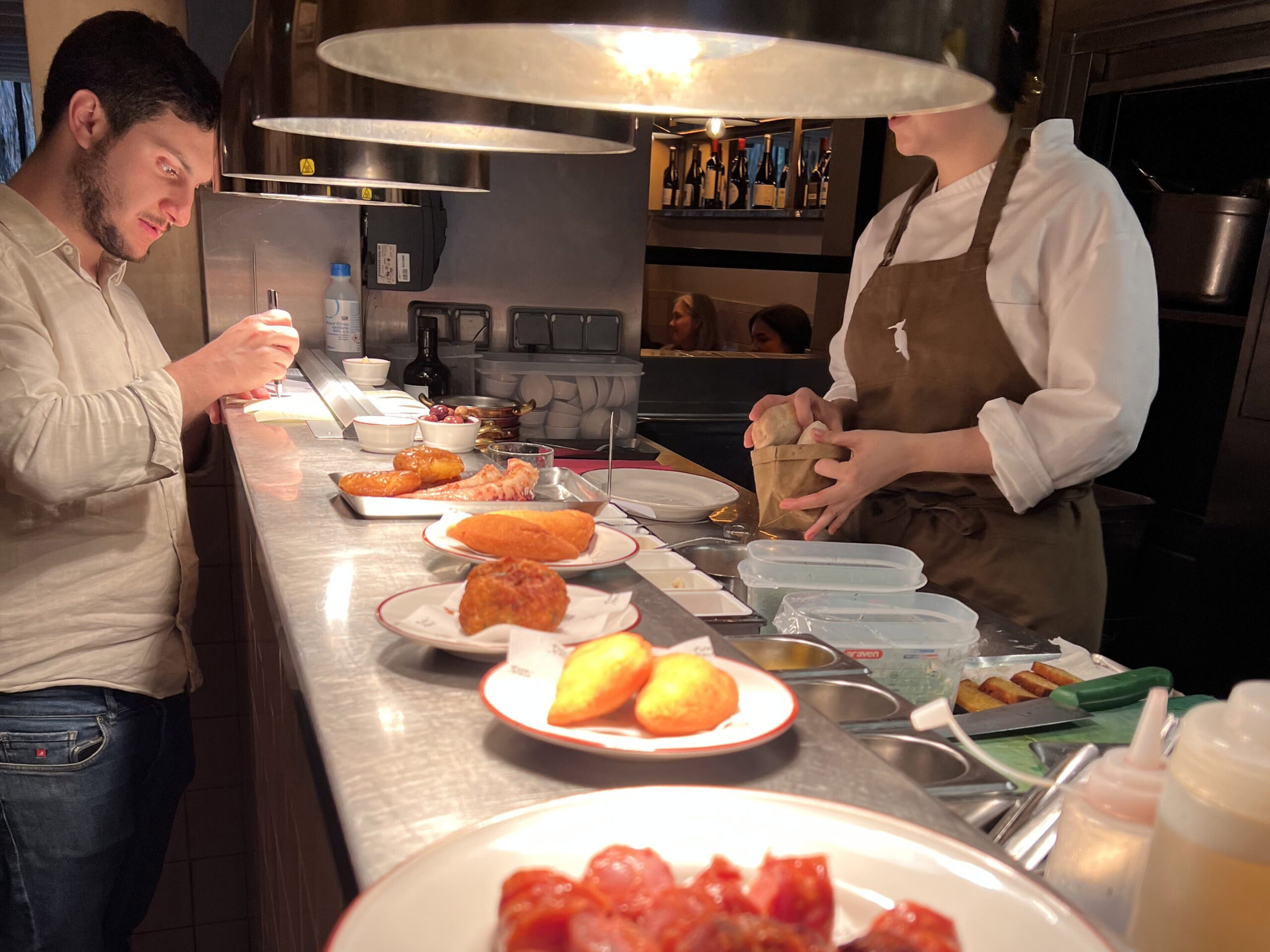 6 Best Portuguese Restaurants in Lisbon (Local & Authentic) 4 Succulent chorizo sausages served at a bustling Lisbon restaurant, showcasing authentic Portuguese cuisine in a cozy, vibrant atmosphere perfect for food lovers exploring Lisbon’s local flavors.