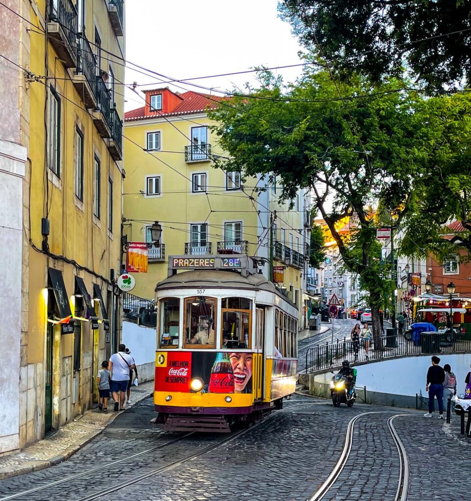 Historic Lisbon Tram 28 navigating through narrow streets in Portugal.
