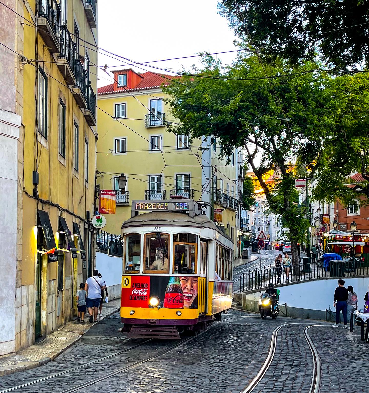 Historic Lisbon Tram 28 navigating through narrow streets in Portugal.