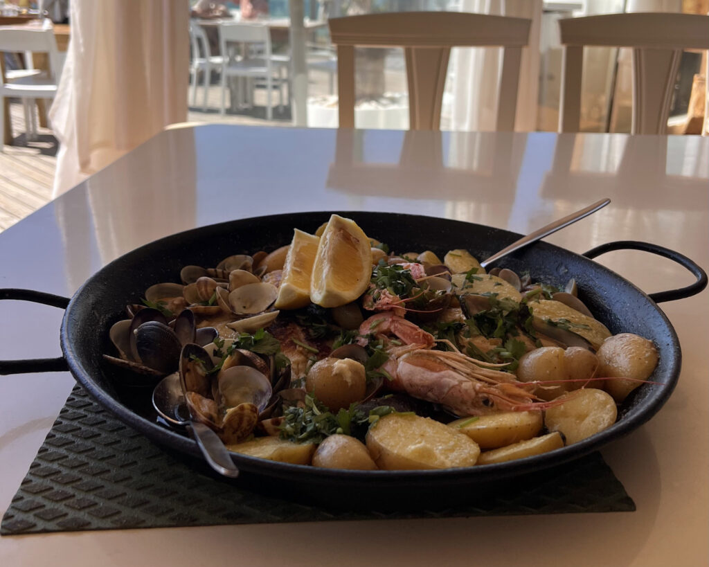 Lisbon Food Guide: What to Eat + Where to Eat (Local Tips + Map) 2 Fresh seafood dish with shrimp, mussels, and potatoes garnished with lemon wedges and herbs at a Lisbon restaurant.